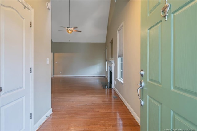 foyer featuring ceiling fan, high vaulted ceiling, and light hardwood / wood-style flooring