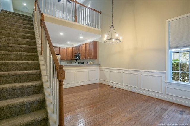 kitchen with an inviting chandelier, pendant lighting, and light wood-type flooring