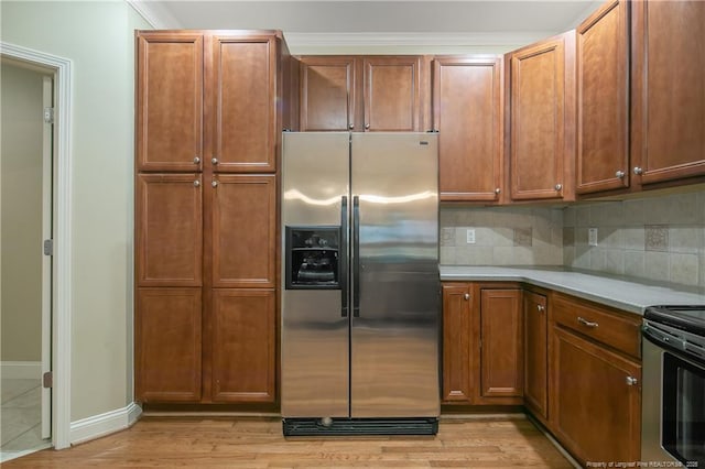 kitchen featuring stainless steel appliances, decorative backsplash, and light hardwood / wood-style flooring