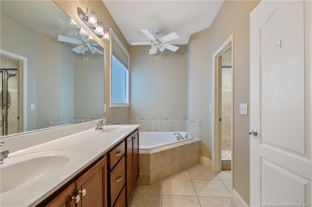 bathroom featuring plus walk in shower, tile patterned floors, ceiling fan, and vanity