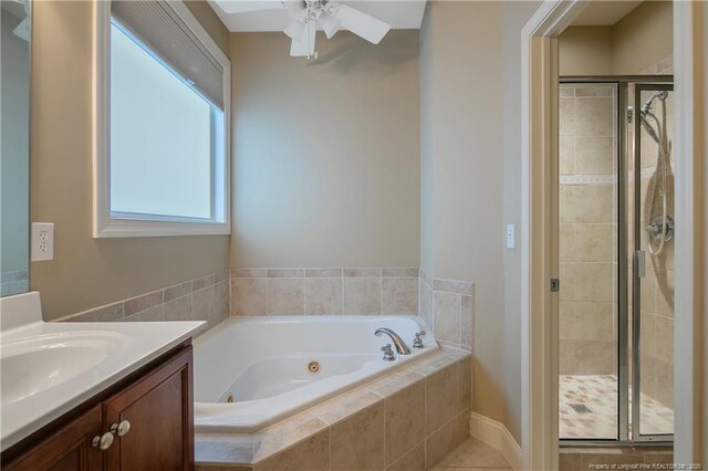 bathroom featuring ceiling fan, vanity, and shower with separate bathtub