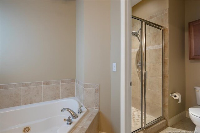 bathroom with shower with separate bathtub and toilet