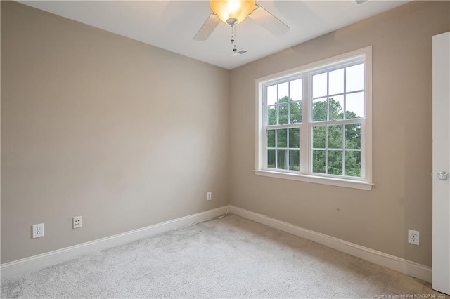 carpeted spare room with ceiling fan