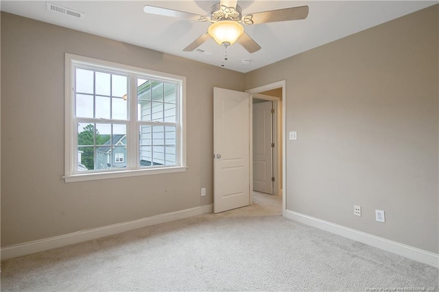 carpeted empty room featuring ceiling fan