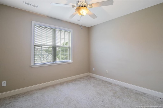 spare room with ceiling fan and light carpet