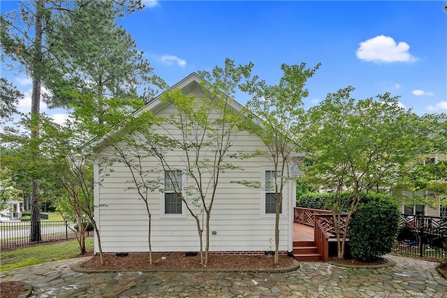 view of home's exterior with a wooden deck