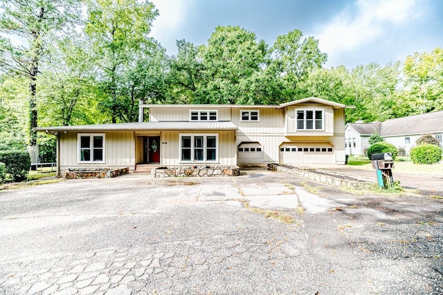 view of front of property featuring a garage and a porch