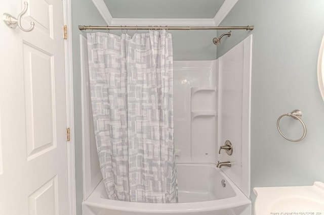 bathroom featuring crown molding and shower / tub combo with curtain