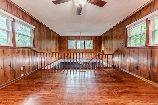 empty room with hardwood / wood-style flooring and a healthy amount of sunlight