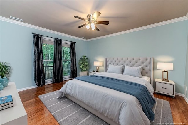 bedroom featuring ceiling fan, ornamental molding, and hardwood / wood-style floors