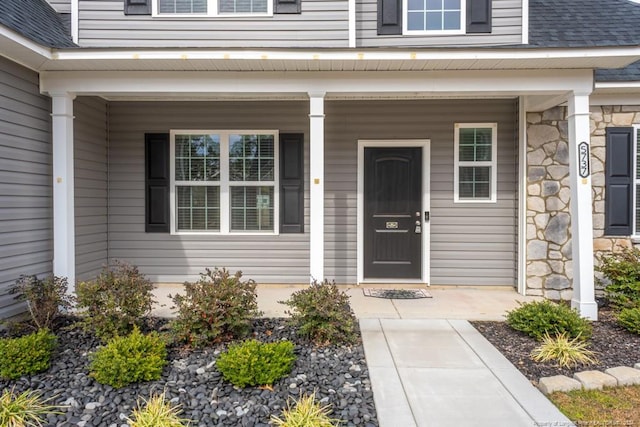 5737 Pooh Ave, Stedman, NC 28391 - entrance to property featuring covered porch, stone siding, and a shingled roof