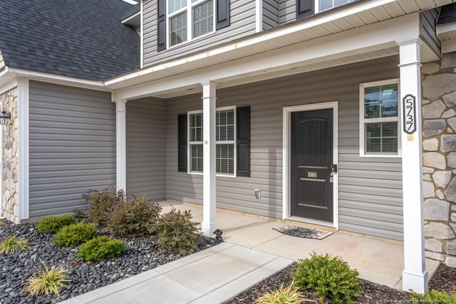 5737 Pooh Ave, Stedman, NC 28391 - entrance to property with a porch, a shingled roof, and stone siding