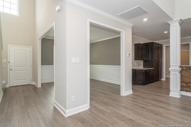 5737 Pooh Ave, Stedman, NC 28391 - hall featuring ornate columns, ornamental molding, light wood-style flooring, recessed lighting, and wainscoting