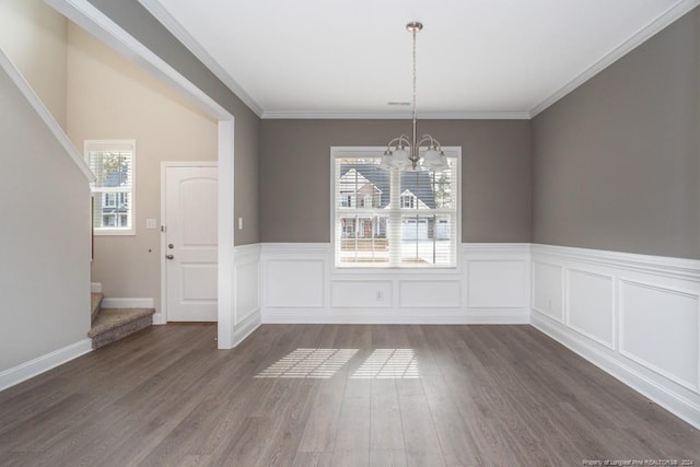 5737 Pooh Ave, Stedman, NC 28391 - unfurnished dining area featuring a chandelier, healthy amount of natural light, dark wood-type flooring, stairway, and wainscoting