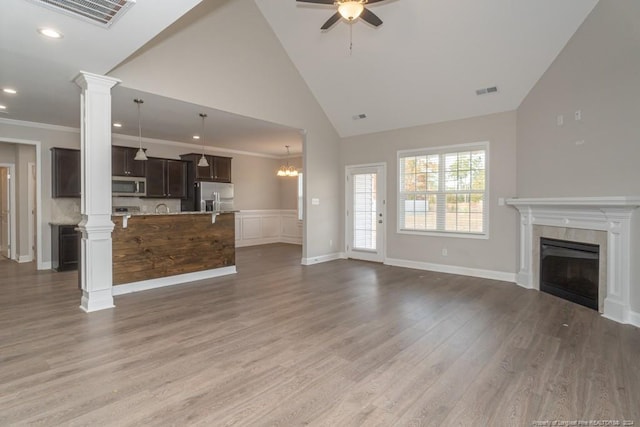 5737 Pooh Ave, Stedman, NC 28391 - unfurnished living room featuring a ceiling fan, wood finished floors, a tile fireplace, high vaulted ceiling, and recessed lighting