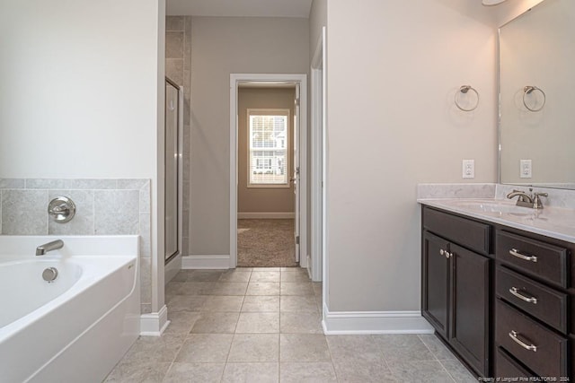 5737 Pooh Ave, Stedman, NC 28391 - bathroom featuring vanity, a garden tub, tile patterned flooring, a stall shower, and baseboards