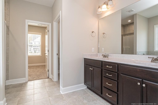 5737 Pooh Ave, Stedman, NC 28391 - full bathroom featuring double vanity, baseboards, and a shower