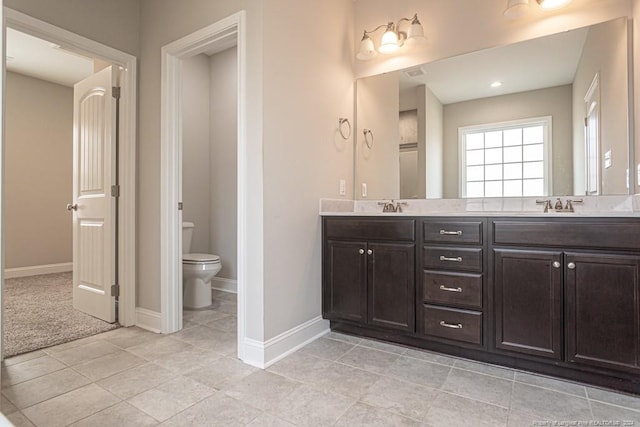 5737 Pooh Ave, Stedman, NC 28391 - bathroom with double vanity, toilet, baseboards, and tile patterned floors