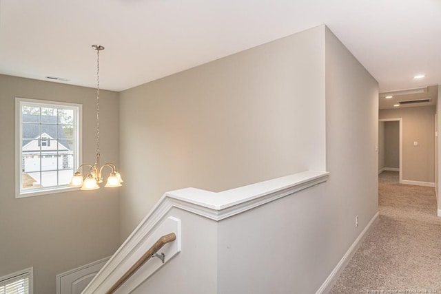 5737 Pooh Ave, Stedman, NC 28391 - hall featuring an upstairs landing, carpet floors, baseboards, and a chandelier