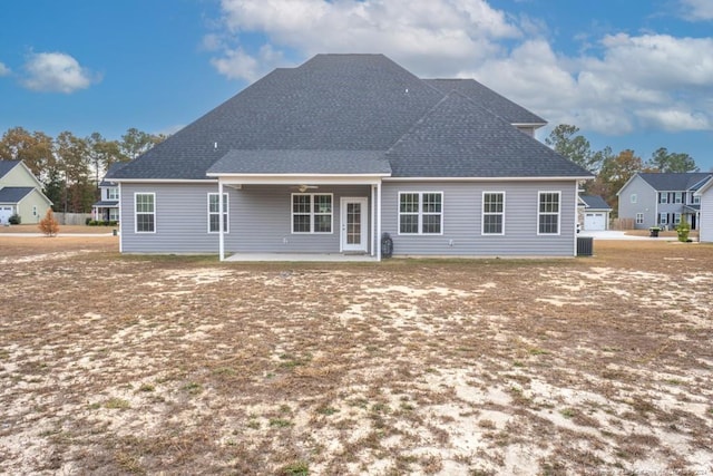 rear view of house with central AC and a patio area