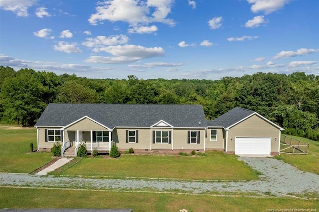 single story home featuring covered porch, a front yard, and a garage