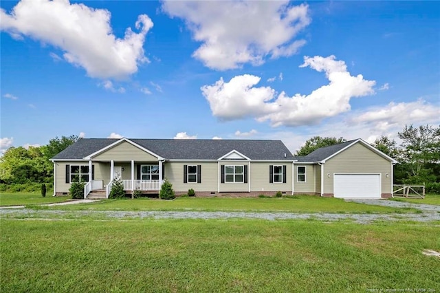 ranch-style home featuring a garage, a porch, and a front lawn