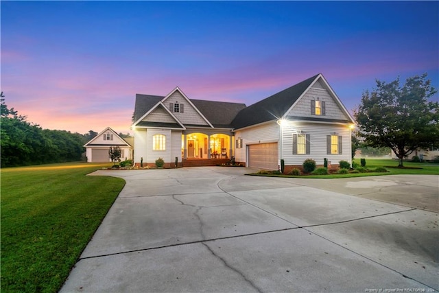 view of front of house featuring a yard and a garage