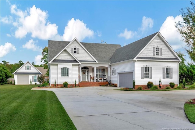 view of front facade featuring a front lawn, a porch, and a garage