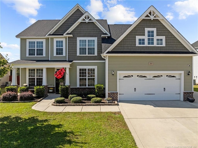 craftsman-style home with cooling unit, a garage, and a front lawn