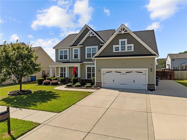 craftsman house featuring a garage and a front lawn