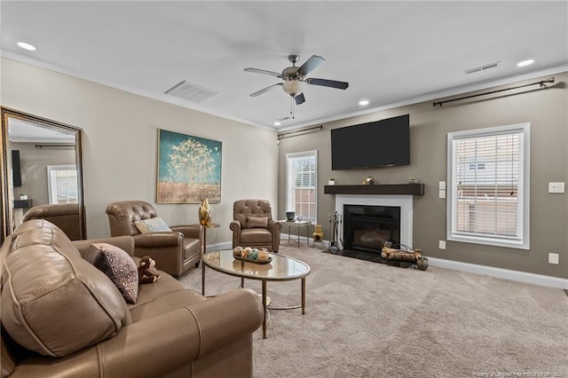 living room featuring ornamental molding, a wealth of natural light, and light colored carpet