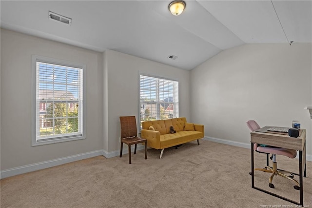 office area featuring light colored carpet and vaulted ceiling