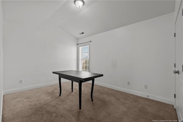 unfurnished office featuring vaulted ceiling and carpet flooring