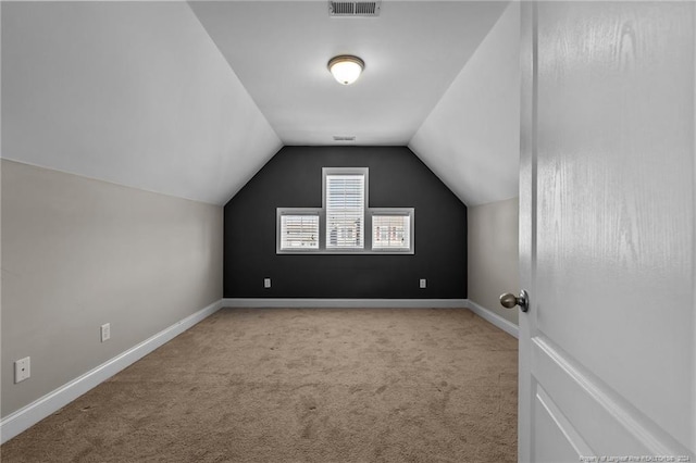 bonus room featuring light carpet and lofted ceiling