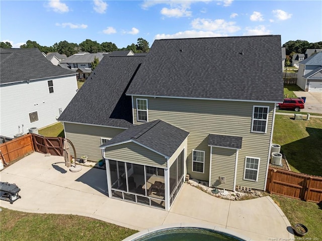 rear view of property featuring a patio and a sunroom