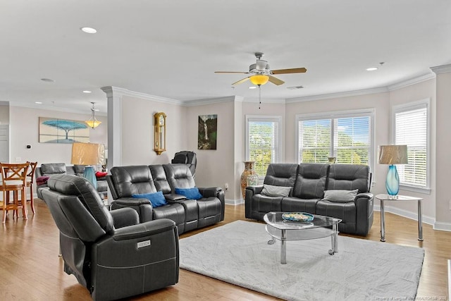 living room with ceiling fan, light wood-type flooring, and ornamental molding