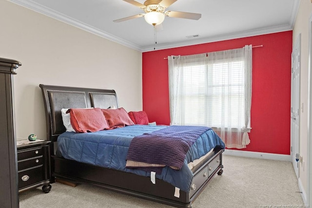 carpeted bedroom with ornamental molding and ceiling fan