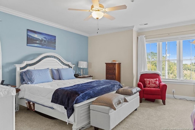 carpeted bedroom with ceiling fan and ornamental molding