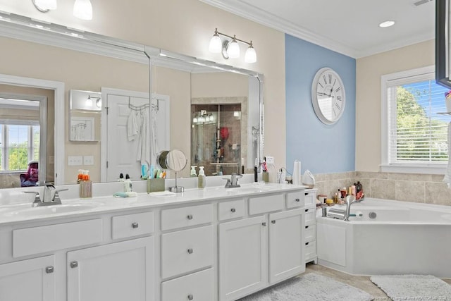 bathroom with ornamental molding, a tub to relax in, and vanity