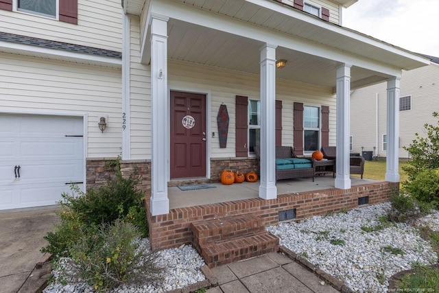 entrance to property with a porch and a garage