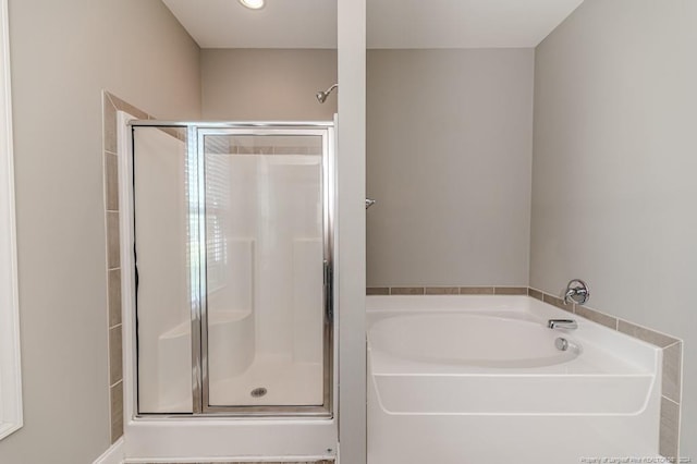 bathroom with shower with separate bathtub