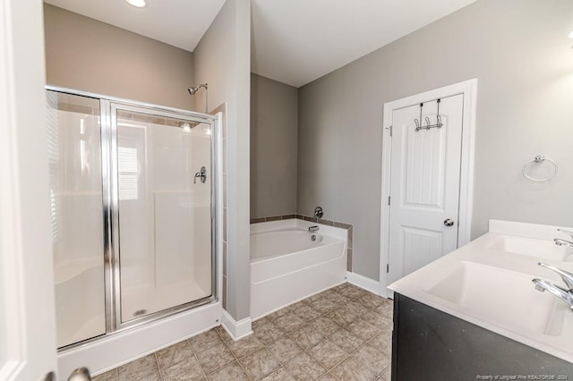 bathroom with tile patterned flooring, plus walk in shower, and sink