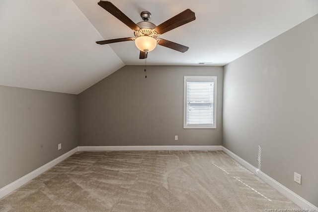 additional living space with light carpet, vaulted ceiling, and ceiling fan