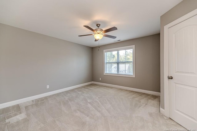 carpeted empty room featuring ceiling fan