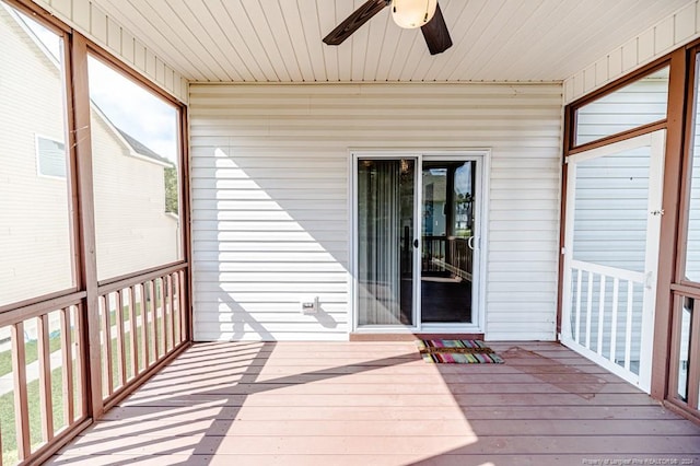 unfurnished sunroom with ceiling fan and wood ceiling