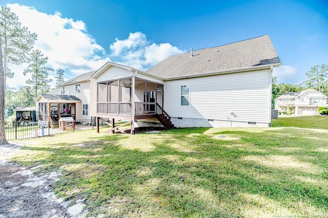 back of property with a yard and a sunroom