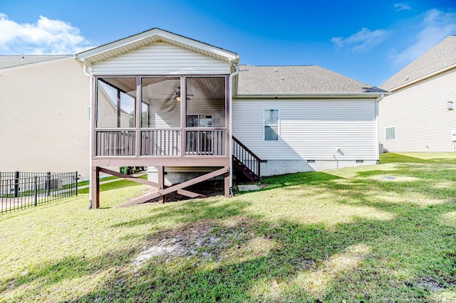 rear view of property featuring a sunroom and a yard