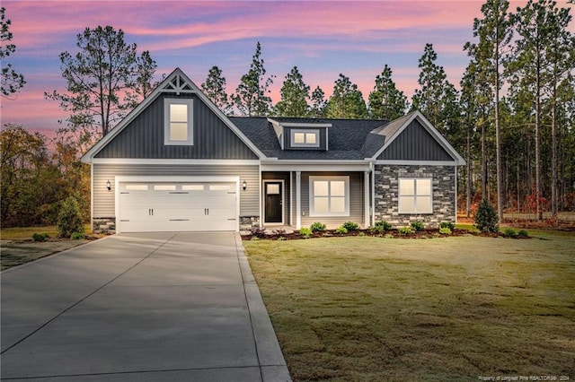 craftsman-style house with a yard and a garage