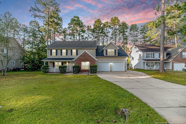 3375 Carolina Way, Sanford, NC 27332 - view of front facade featuring covered porch, a garage, driveway, and a lawn