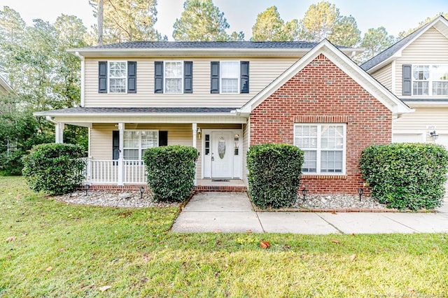 front of property featuring a front lawn and covered porch